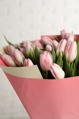 Beautiful bouquet of fresh pink tulips on light background, closeup