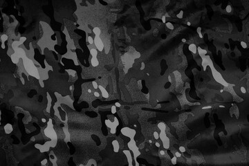 Texture of crumpled camouflage fabric as background, top view. Black and white effect