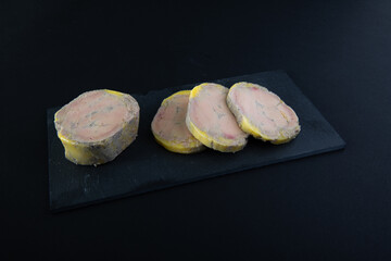 slices of foie gras placed on a black slate © Loks