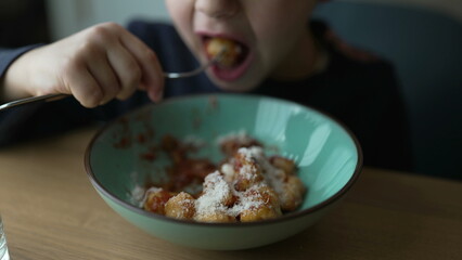 Little Boy Eating Gnocchi, Close-Up of Pensive Five-Year-Old Enjoying Meal