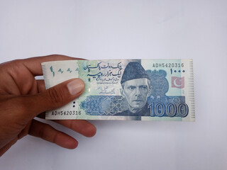 Pakistani 1000 Note hold in hand, Isolated on white background.