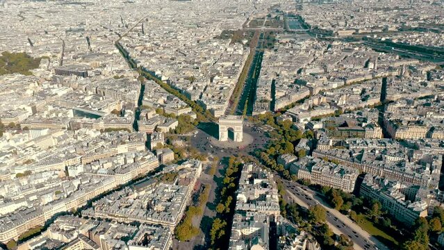 PARIS, FRANCE - MAY 30, 2023: Aerial view over Triumphal Arc traffic in central Paris cityscape. Famous touristic landmark, world heritage of architectural masterpieces.