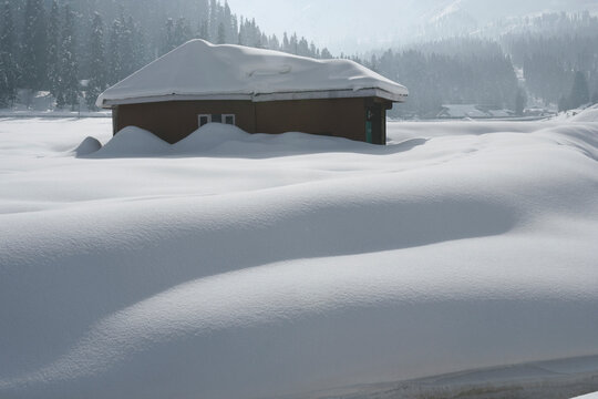 Gulmarg, Jammu and Kashmir /  India - December 19, 2019 : A View of the small hut covered with snow in Gulmarg, Jammu and Kashmir.