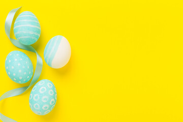 Blue easter eggs on color background, top view