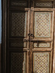A painted vintage historical wooden door in the old town of Cordoba
