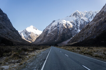 road to mild ford sound with snowy mountain in the background