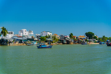 Fishing boats on the river.
The Kai River in Nha Trang in Vietnam. The urban landscape.