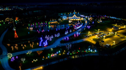 Expansive Aerial View Of A Festive Grounds Illuminated With Holiday Lights Featuring A Path To A...