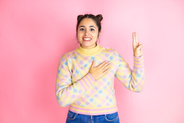 Young beautiful woman wearing casual sweater over isolated yellow background smiling swearing with...
