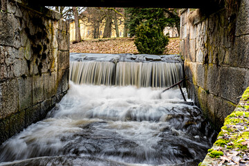 water flowing through the old stone