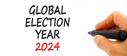 Global election year 2024 symbol. Concept words Global election year 2024 on beautiful white paper. Beautiful white background. Voter hand. Business Global election year 2024 concept. Copy space