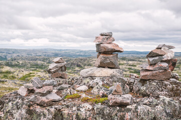 Different stones stacked in a balanced formation in the tundra