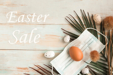 Easter sale. Chicken egg in face medical mask and palm branch. Easter holiday during the...