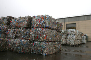 Waste sorting factory. Cubes of pressed metal cans.