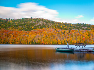 Lac-du-missionaire, Canada: Oct.10 2022: Morning fog on the lake of Lac-du-missionaire with colorful leaves in Quebec in a sunny autumn day