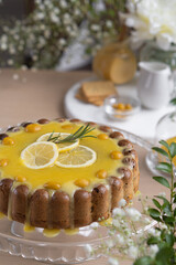 Lemon cupcake with lemon filling on a light table among flowers