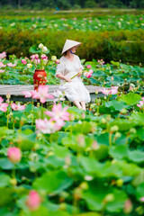 Woman at lotus flower lake - 744184592