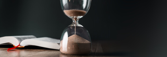 Hourglass and open book