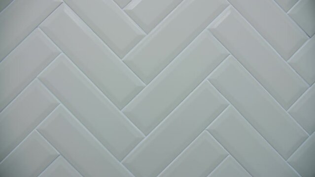 Light ceramic tiles at an angle in the bathroom