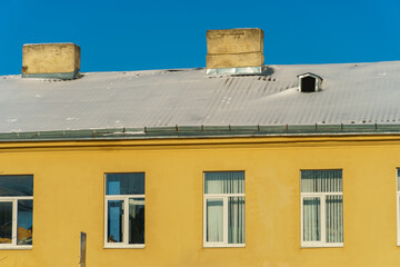 Snow and ice on the roofs of buildings. Icicles hang from the roofs of houses. The probability of the roof collapsing under the weight of snow.