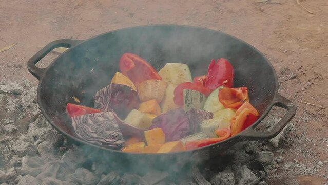 Cooking a vegetable-based vegetarian lunch while camping. roasted vegetables in the paraguayan chaco