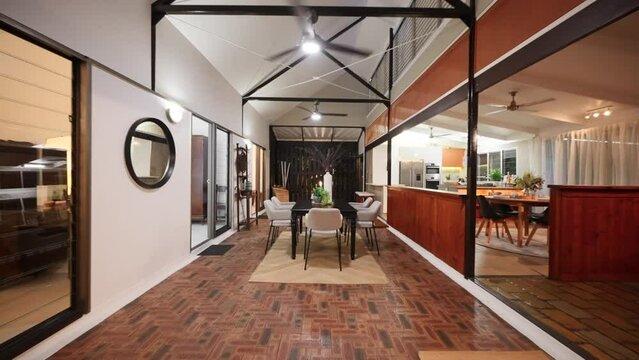 Tropical kitchen table reverse dolly to living room with large open space of Balinese style house