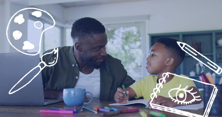 Image of painting icons over happy african american father and son doing homework