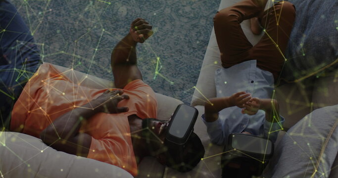 Image of constellations over happy african american father wearing vr headset