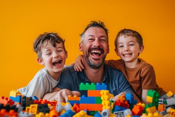 Naklejka premium A father and his two sons beam with joy as they play indoors, their faces lighting up as they build a colorful lego wall together
