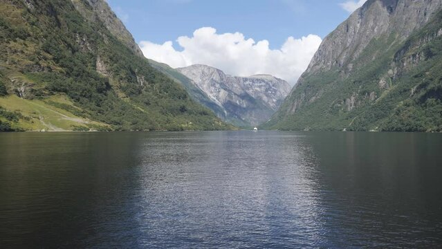 A journey on a lake surrounded by mountains the fjords.