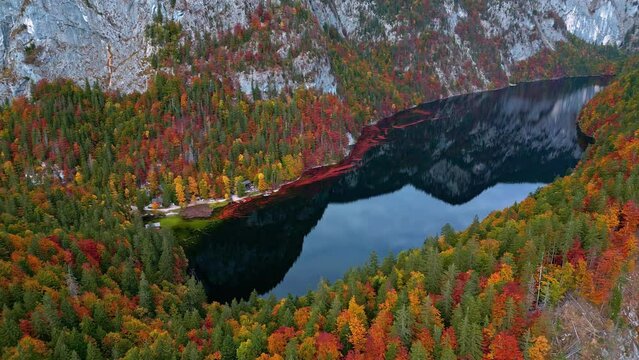 Crystal clear lake Toplitz below mountain cliffs and autumn forests.