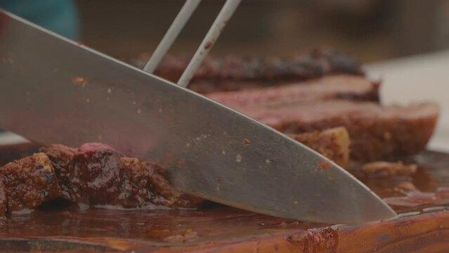 Chef cutting the roast beef, juicy and extremely soft. Paraguayan Barbecue