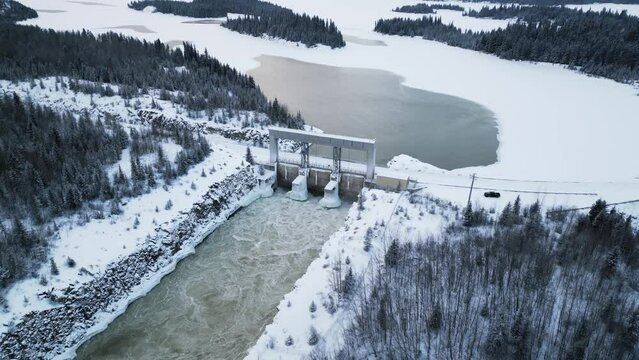 Aerial Drone Shot Rushing Water Notigi Hydro Electric Power Lake Dam in Snowy Northern Winter Manitoba Canada