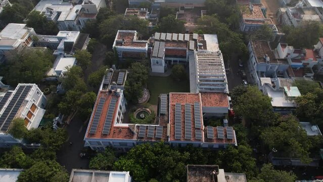 SAerial view of the Anakula Vinayagar Temple and Sri Aurobindo Ashram, two spiritual centres in Pondicherry. The nearby beach and city house have solar panels.