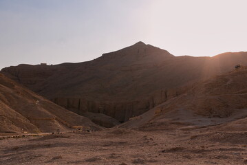 View over valley of kings at Luxor, Egypt during sunset, mountain resembling a pyramid