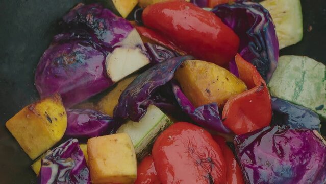 Close-up of  a vegetable-based vegetarian lunch while camping. roasted vegetables in the paraguayan chaco. Slowmotion