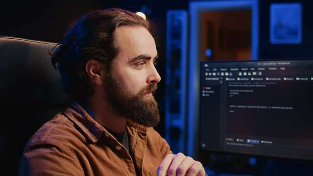 Happy software engineer feeling satisfied after removing all bugs while coding on computer, close up. Joyous IT admin looking at PC screen, pleased after solving script errors, camera B close up