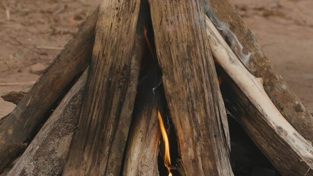 Burning wood: slow motion video of tongues of fire and ember smoke. Preparing the Paraguayan barbecue