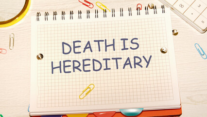 DEATH IS HEREDITARY text written on a notebook in a cage