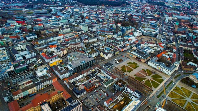 Aerial around the downtown of the city Kassel in Hessen, Germany on a cloudy day in early spring. © Simona