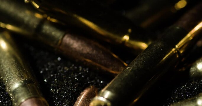 Macro detail closeup of 300 AAC Blackout bullets on gunpowder dust, circle pan