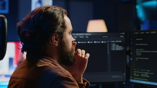 Developer overthinking solutions while doing programming during remote job shift in home office. IT admin working on computer in apartment late at night, thinking how to fix bugs, camera A close up