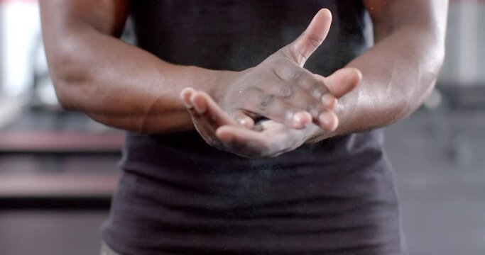 Fit African American man stretches his hands before a workout