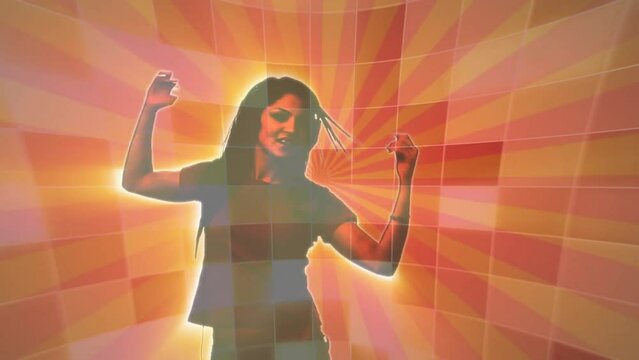 Animation of woman in headphones dancing over rotating orange and pink lights