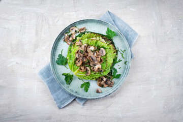 Traditional savoy cabbage lasagne with mashed potatoes and mushrooms served as top view on a design...