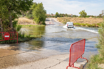 a vehicle crossing the Cidacos river in the summer in Calahorra, province of La Rioja, Spain - 744241567