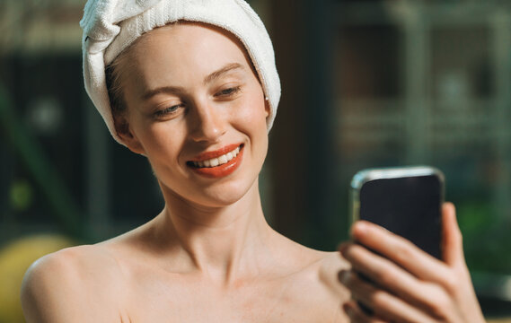 Portrait of close up beautiful caucasian woman in white towel taking video of calm and relaxing nature by using her mobile phone. Pretty girl with beautiful skin take photo. A Side view. Tranquility. - Powered by Adobe
