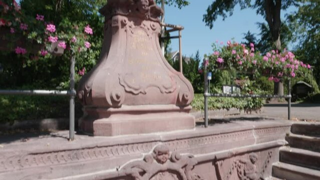 Fountain with a statue of the Virgin Mary in front of the Maria zu den Ketten church in Zell am Harmersbach on a summer's day