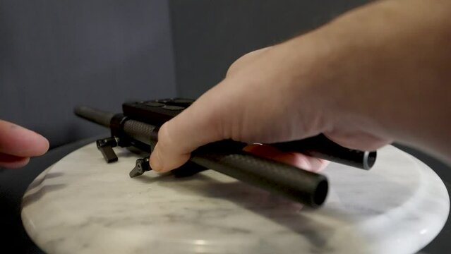 Back side thumbscrews being loosened.