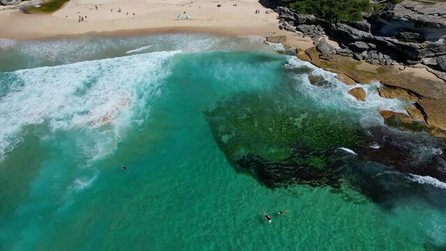 Surfers And Tourists At The Tamarama Beach In Summer. Beachside Suburb In New South Wales, Australia. aerial tilt-up shot